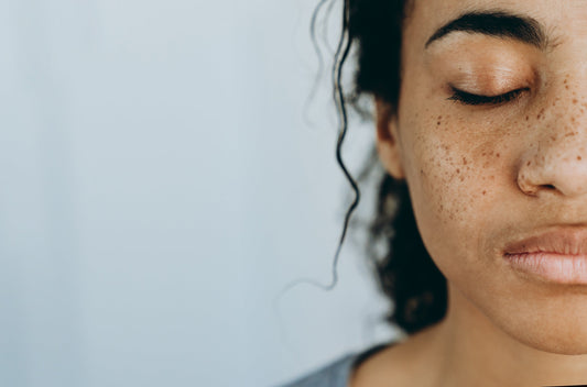 Black woman posing with eyes closed showing half the face